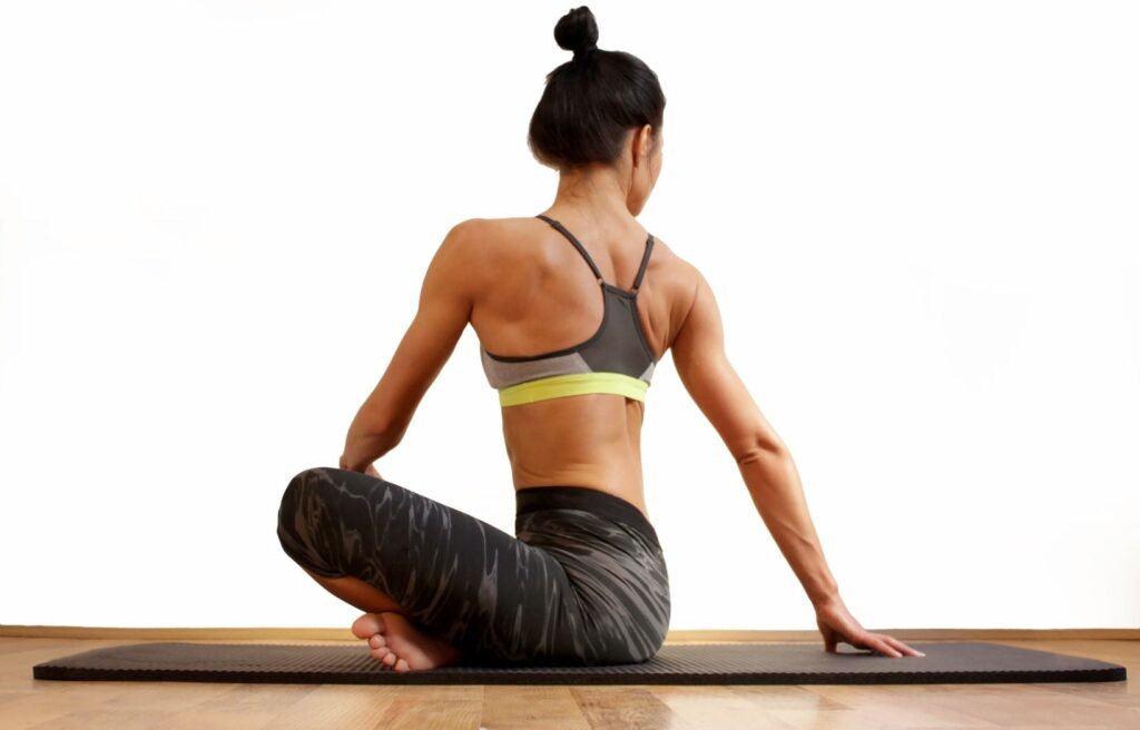 Woman stretching on yoga mat